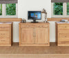 Front angle image of the Baumhaus Mobel Oak Hidden Home Office Hideaway (COR06A) shown with other Baumhaus Mobel Oak furniture